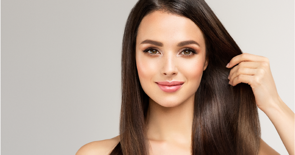 Woman showing Keralase Hair Restoration result with long, smooth, and healthy hair in Woodmere, Ohio | EG Aesthetics